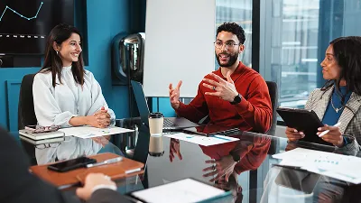 A group of people collaborating or discussing and listening attentively.